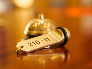 Hotel bell and key lying on the desk